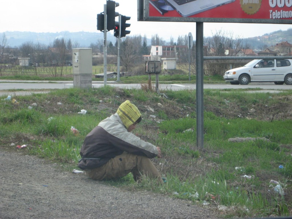 Bosnian Boy Sits in Street