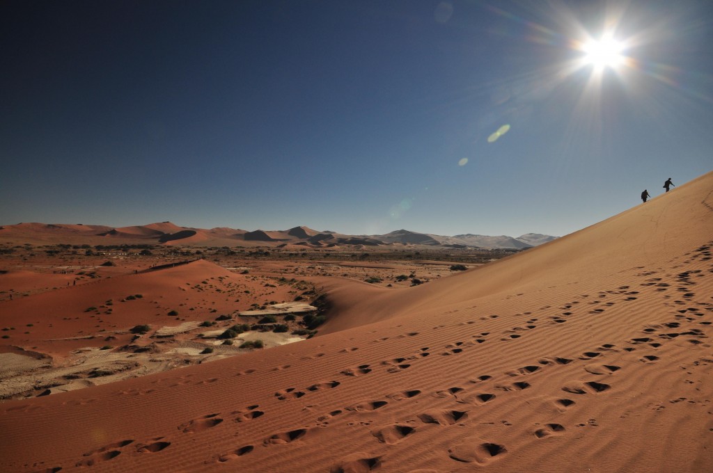 Hikers climb up Sossusvlei Dunes Namibia