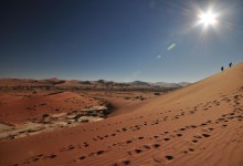 Hikers climb up Sossusvlei Dunes Namibia