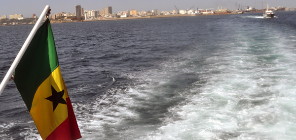 The Dakar Senegal coastline with the Senegalese flag in the foreground