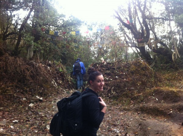 Chandra reaches the top of the trek passing the prayer flags marking the highest point