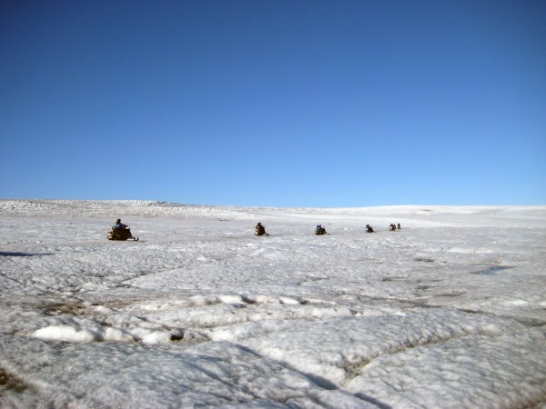 Snowmobiles make their way across the Langjökull Glacier