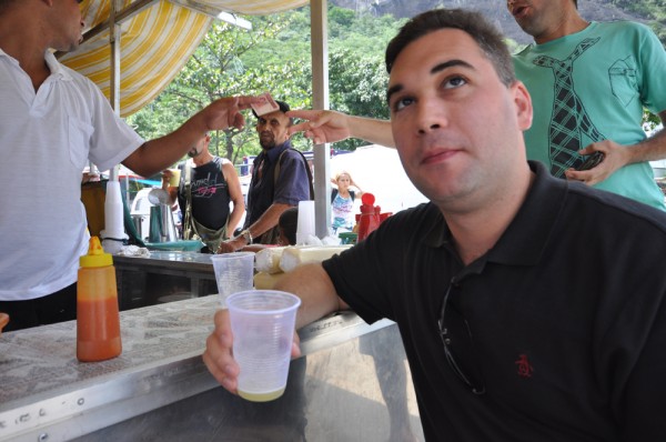 Dave enjoying a glass of fresh sugar cane juice to wash down his "long falafel" in the favelas of Rio