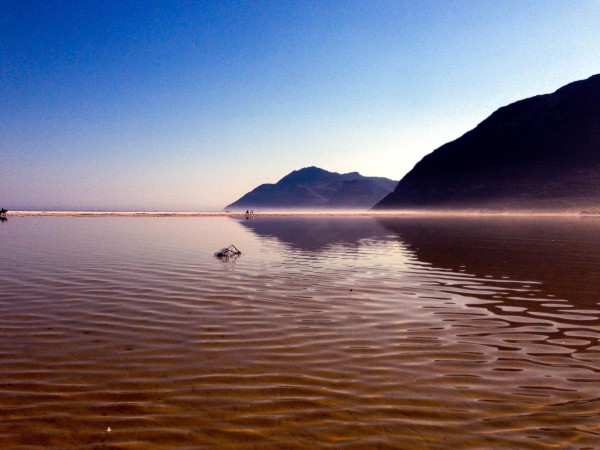 The mountains surrounding Cape Town reflecting in the shallow waters of Nordhoek beach