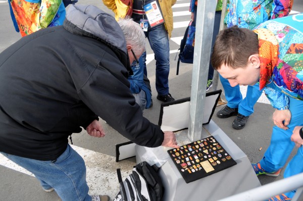 Pin trading taking place on the street outside the Main Press Center in Sochi 