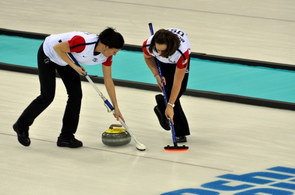 Sweeping the ice in front of the moving curling stone allows control of speed and direction