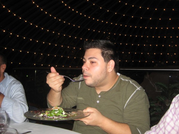 My friend taking a big bite of Minke whale and savoring the fishy flavor 