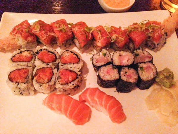 Traditional PRO at the back, spicy tuna roll on the left, yellowtail jalapeno roll on the right and two pieces of salmon nigiri front and center