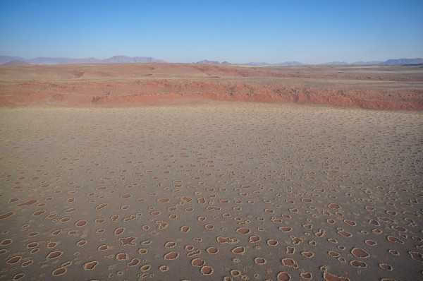 What are the hole looking things on the surface? How were they formed? Nobody knows but this place no longer looks like earth.