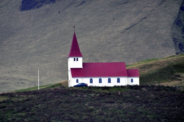 The tiny church on a hill that marks the beginning of the town of Vik