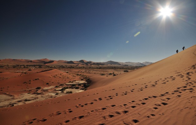 Hikers climb up Sossusvlei Dunes Namibia